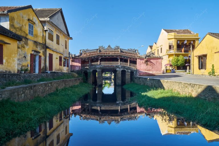 Japanese Covered Bridge (Cau Nhat Ban) with reflection in the Thu Bon River in Hoi An Old Town, Vietnam