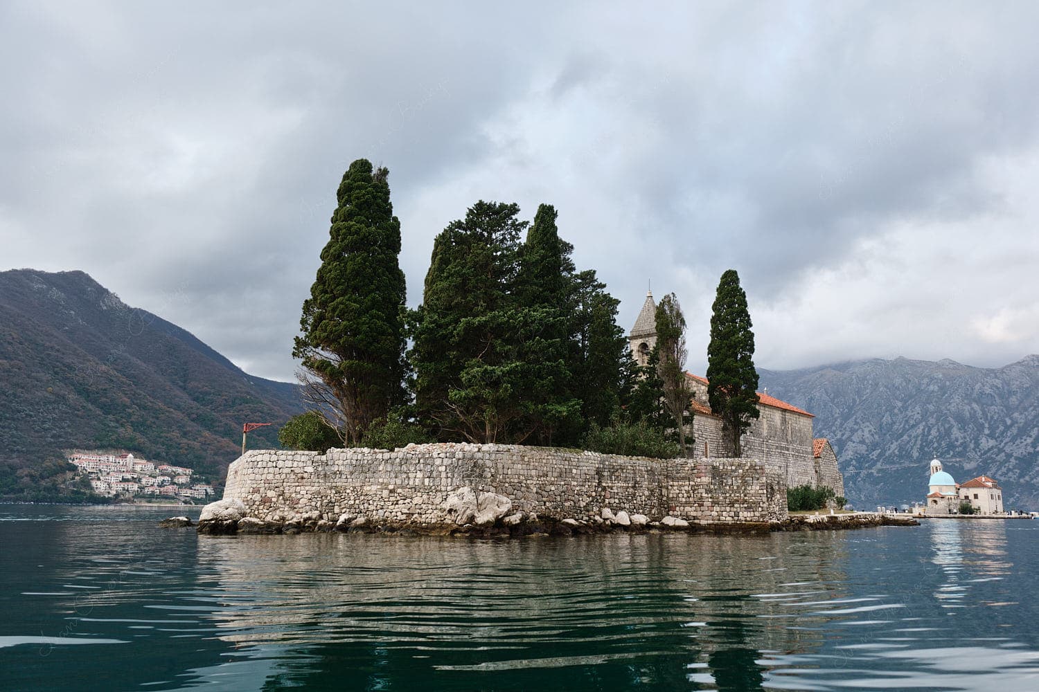 Back view of Saint George Monastery and mountains, Perast, Montenegro Back view of Saint George Monastery and mountains, Perast, Montenegro