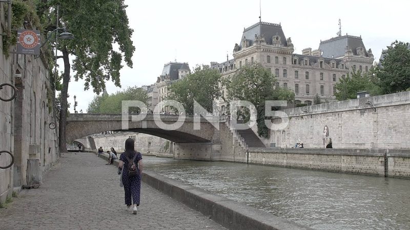 People Relaxing Along The Seine River Promenade, Paris, France People Relaxing Along The Seine River Promenade, Paris, France