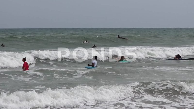 Tourists And Local Ghanaian People Surfing At Kokrobite Beach, Ghana Tourists And Local Ghanaian People Surfing At Kokrobite Beach, Ghana