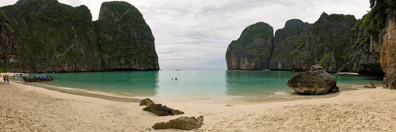 A panoramic view of the beautiful sandy beach, mountains and turquoise water of the one and only Maya Bay beach, Koh Phi Phi Ley, Thailand