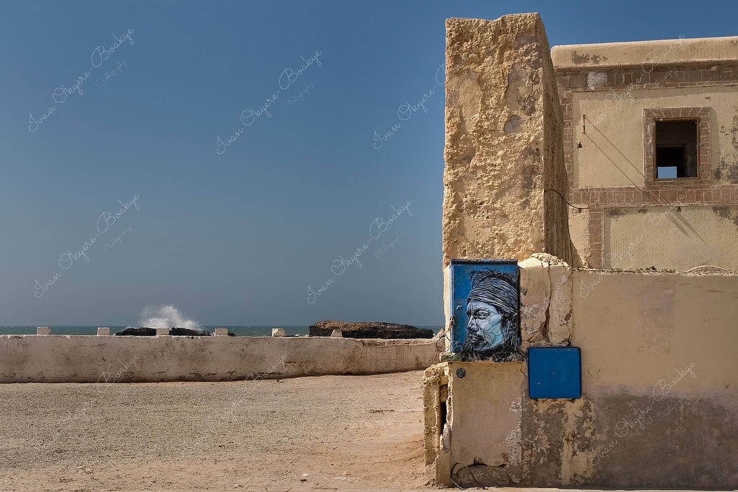 Painting of Jimi Hendrix on the outside wall of a rundown building near the sea walls of Essaouira medina, Essaouira, Morocco