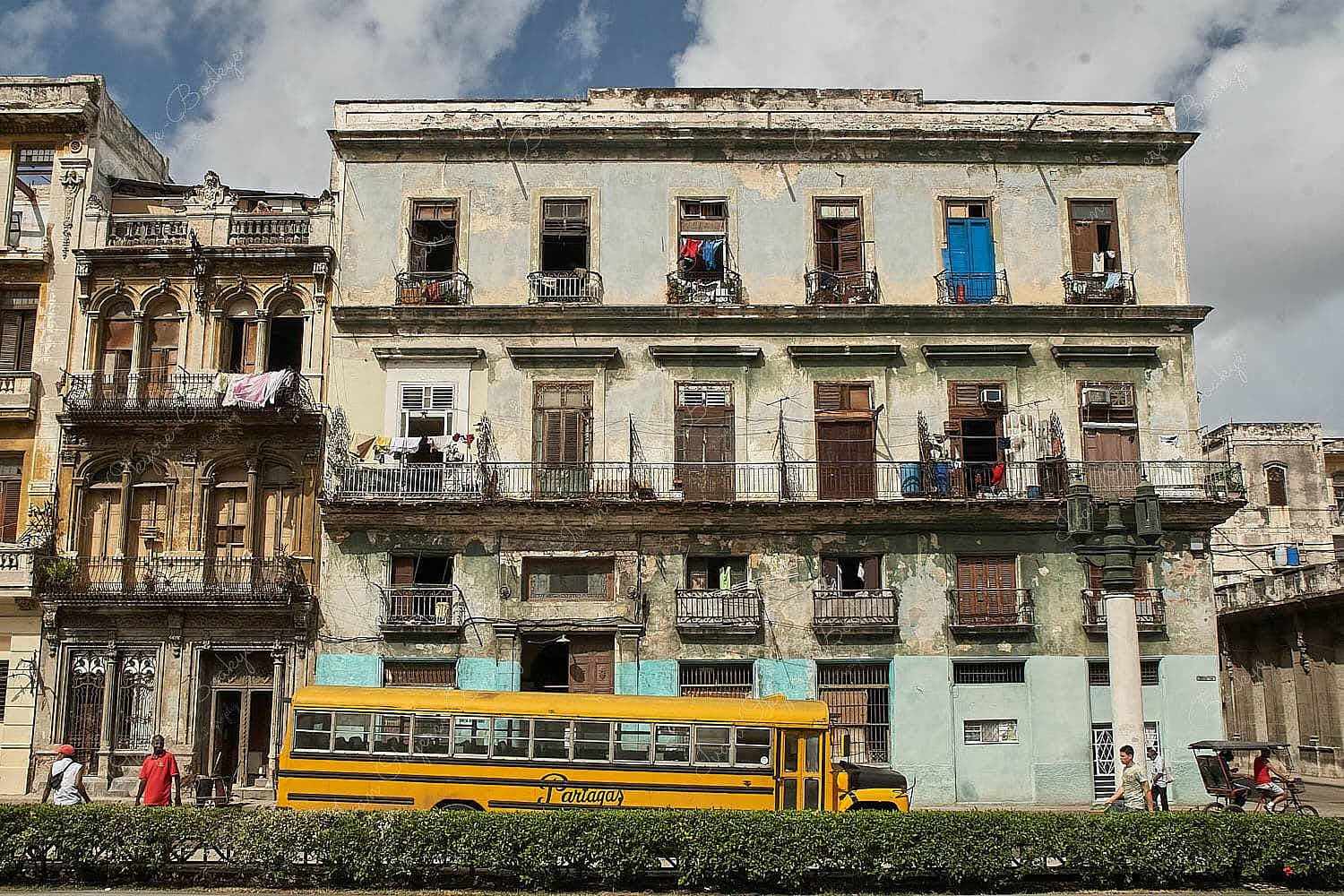 Old yellow Partagas Bus outside old buildings in Centro Habana, Cuba