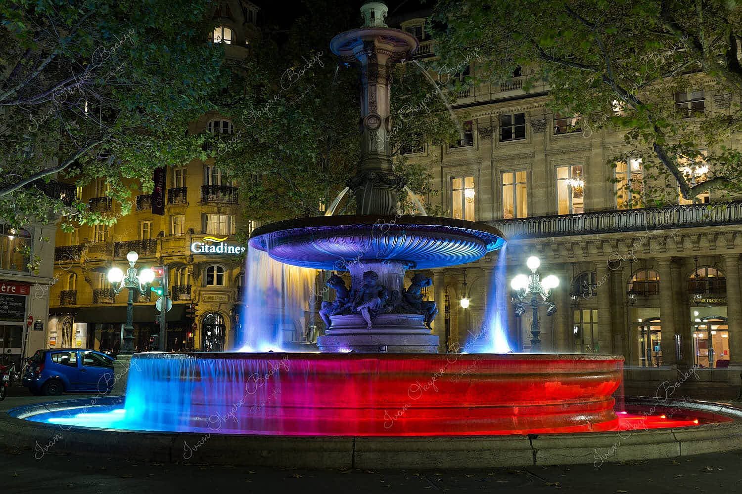 Blue and red illuminated fountain at night, Paris