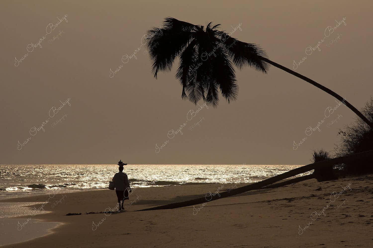 Female beach vendor selling food walking down an empty Elmina Beach at sunset, Ghana