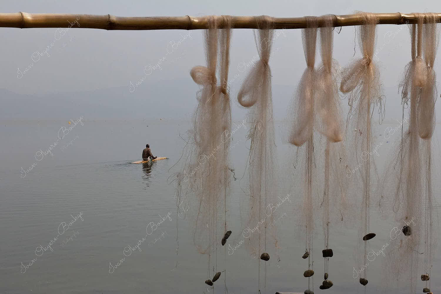Fisherman fishing on Padua with fishing nets drying at Lake Bosumtwi, Ghana
