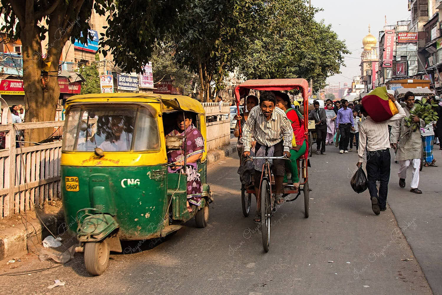 Auto Rickshaw and Bicycle Rickshaw drivers with passengers in Chandni Chowk, Delhi, India