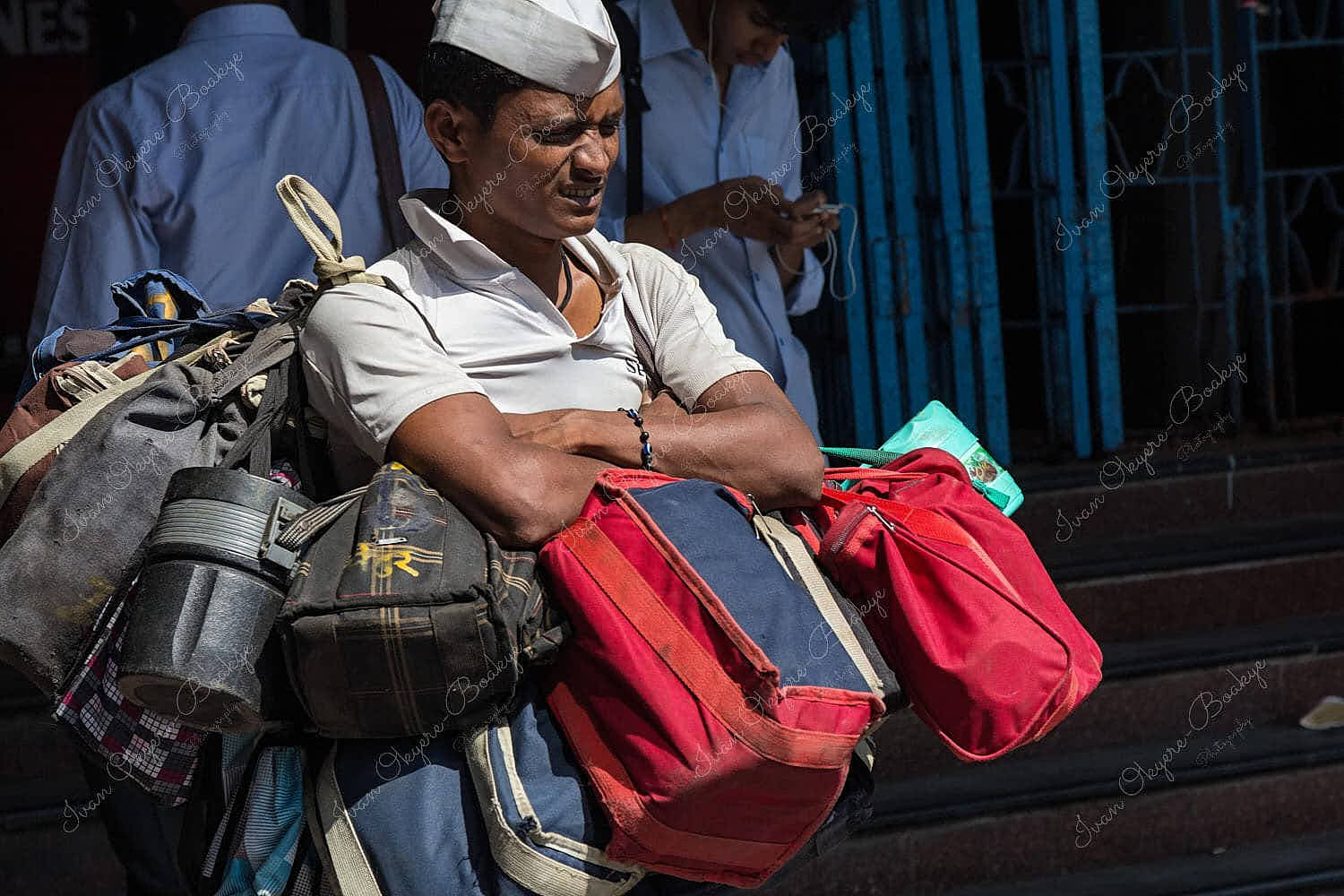 Dabbawala carrying Lunch Dabbas (Tiffin Boxes) for delivery to customers outside Churchgate Railway Station in Mumbai, India