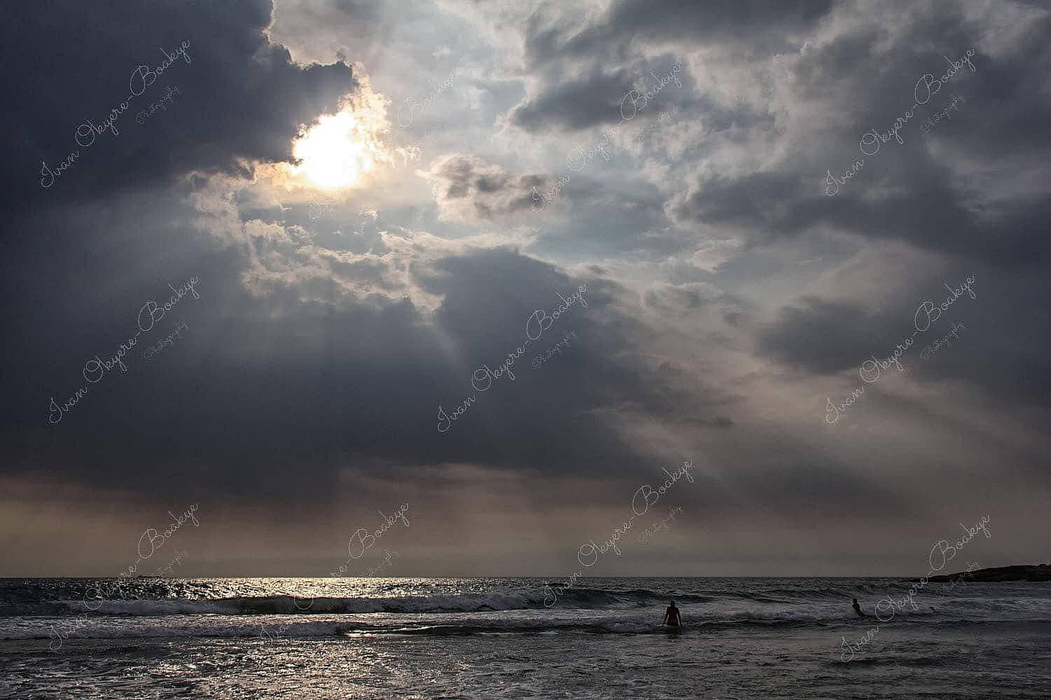 Sun breaking through clouds at Lighthouse Beach in Kovalam, Kerala, India