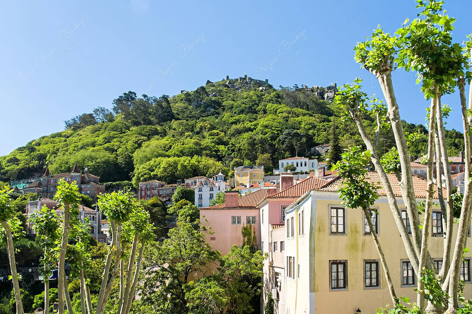 View of the colourful pastel coloured buildings and mountain in Sintra, Lisbon, Portugal