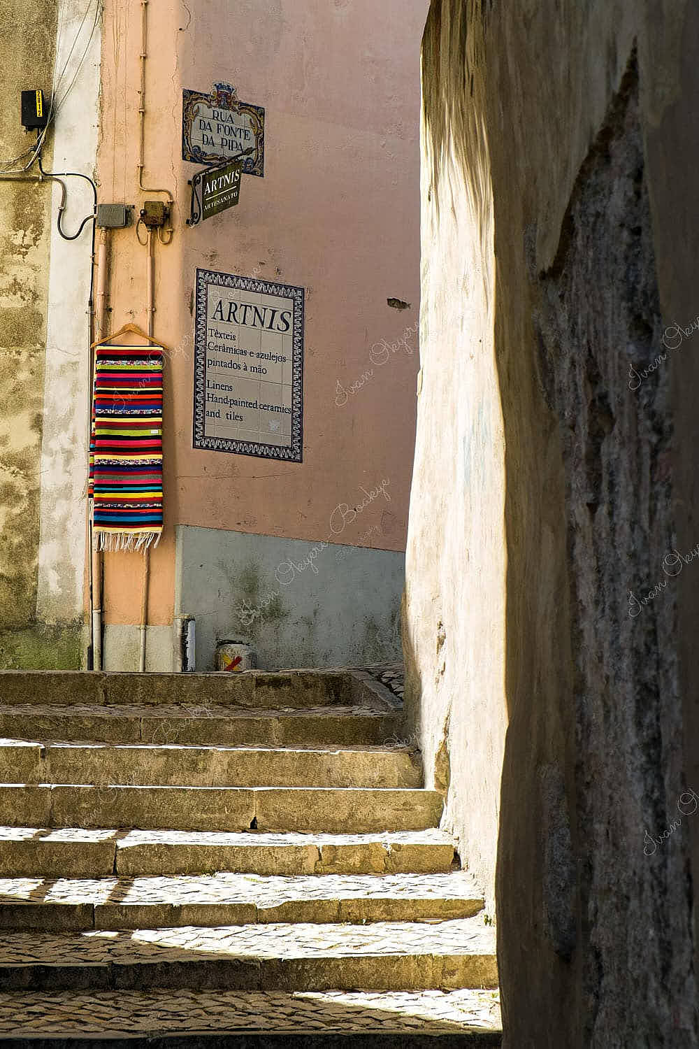 Multicolored blanket hanging in alleyway in Sintra, Lisbon, Portugal