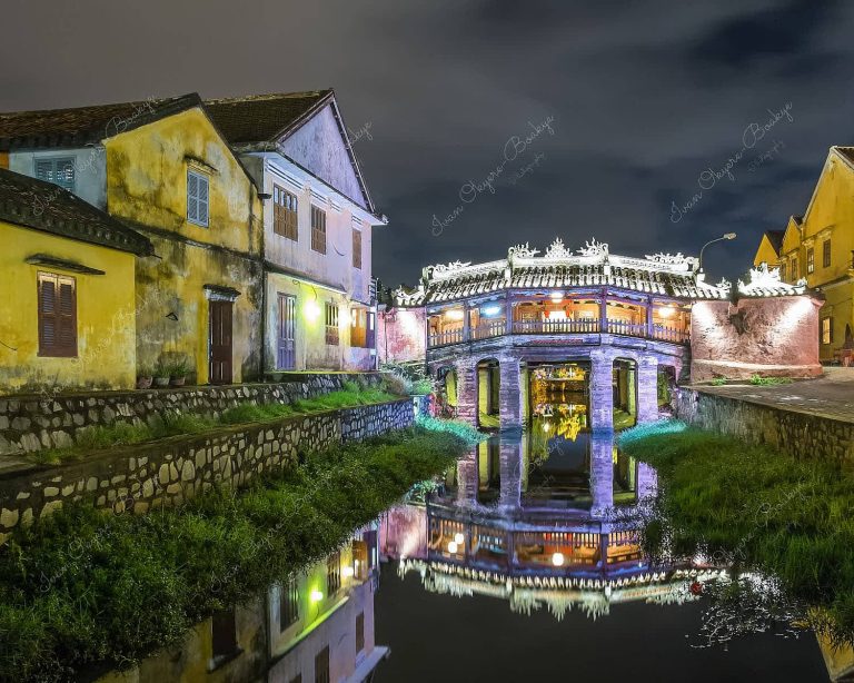 Night illuminated view of Japanese Covered Bridge and Thu Bon River in the old town of Hoi An, Vietnam