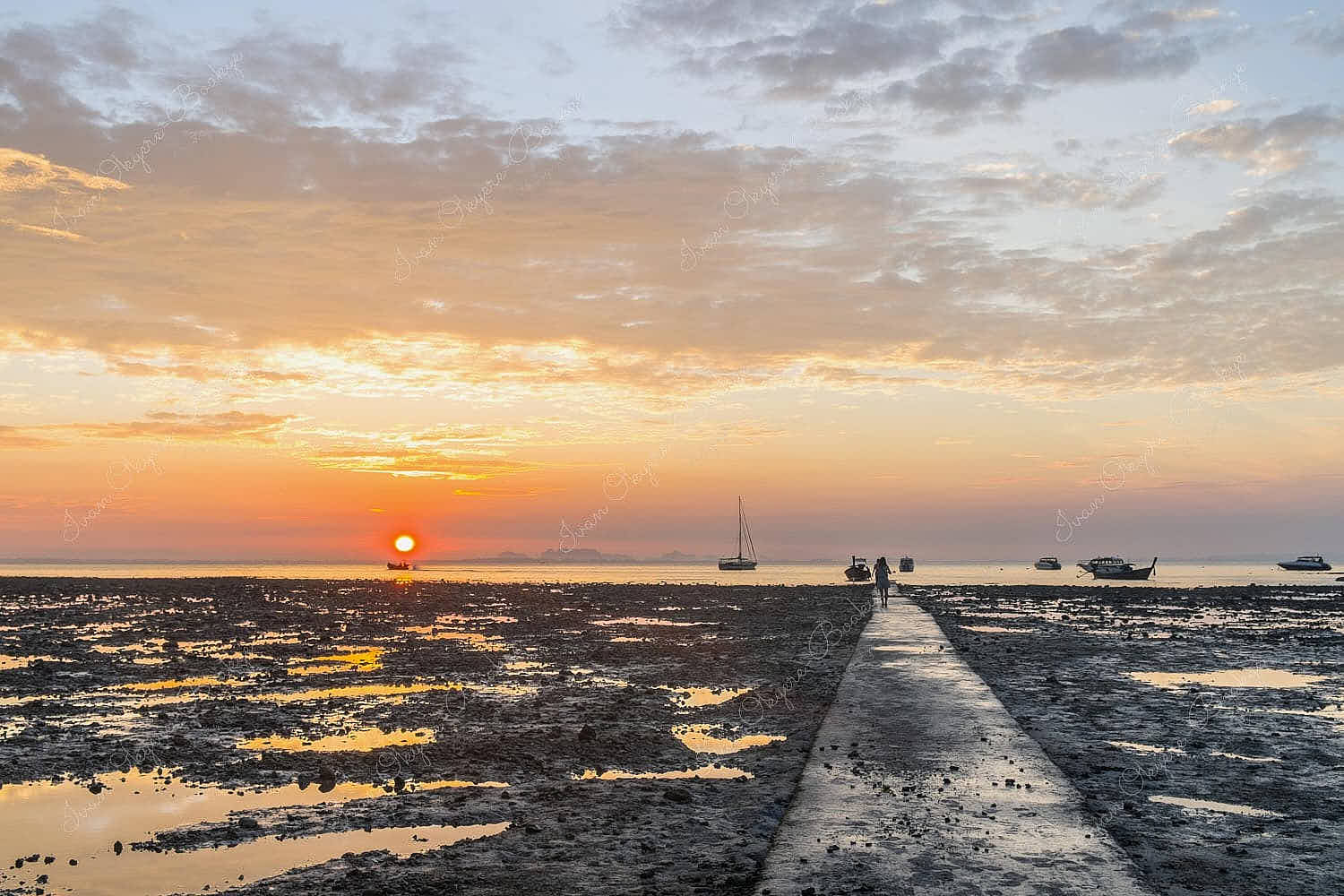 The dramatic gritty sandy landscape of Hat Rai Leh East beach at low tide at sunrise, Railey Bay, Thailand