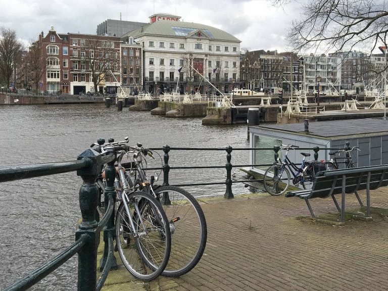 View of bicycles chained to waterfront railings, Amsterdam, Netherlands