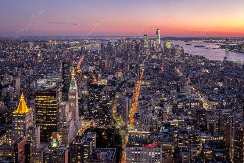Panorama of Manhattan skyline at night with an illuminated 1 World Trade Center in New York, America